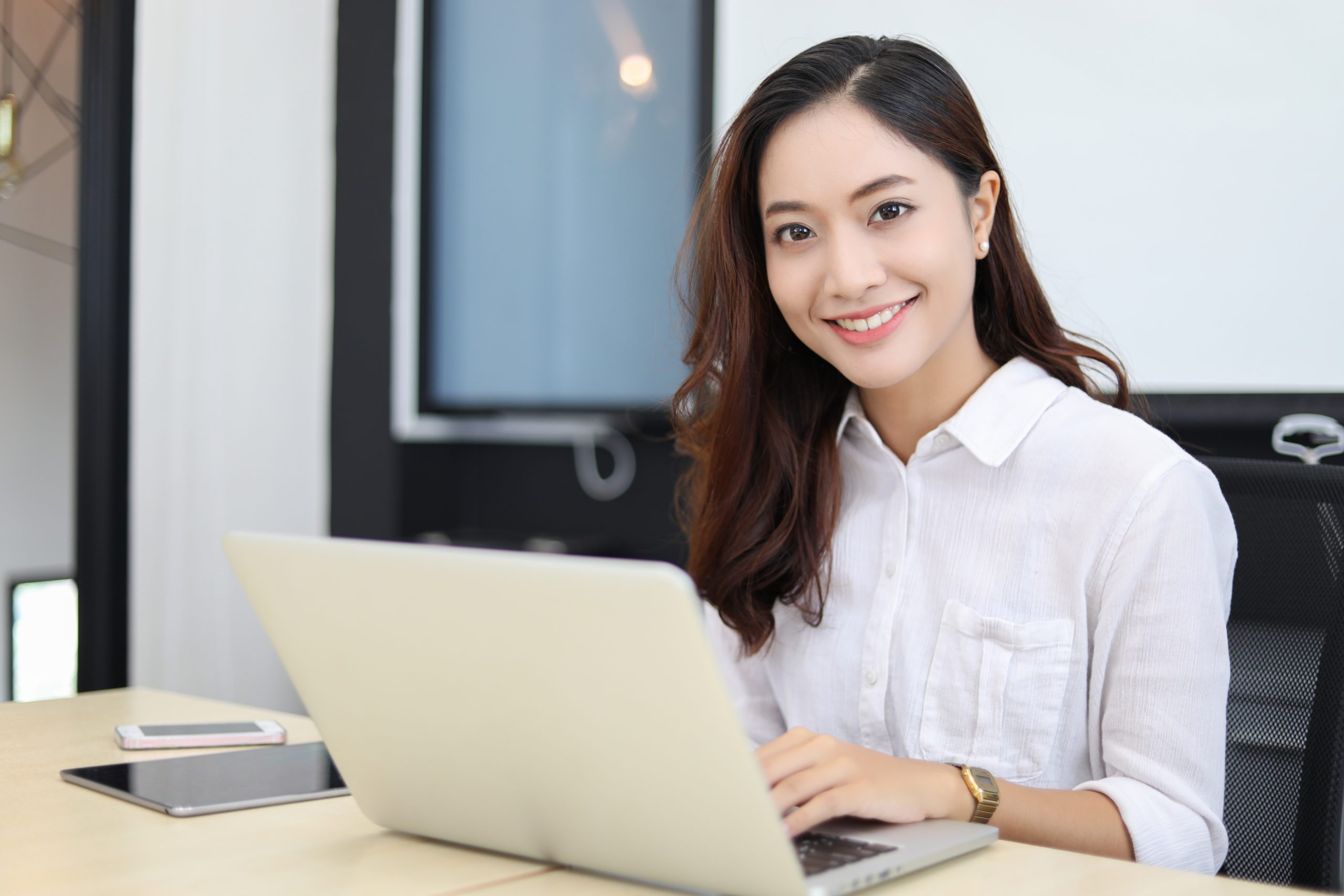 Asian,Business,Women,Using,Notebook,And,Smiling,Happy