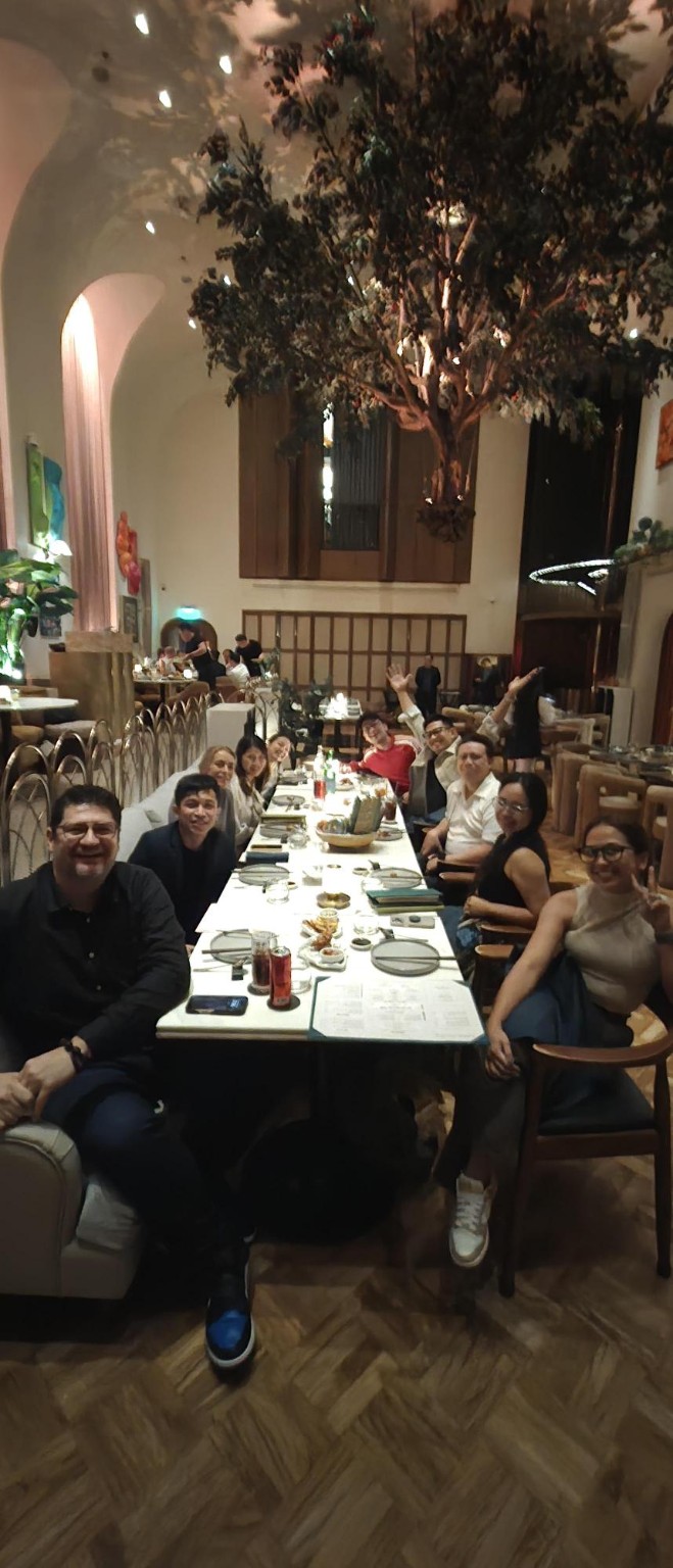 LeapOut managers sharing a meal together at a long restaurant table